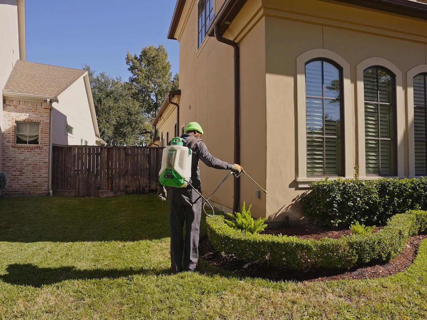 A technician treating the foundation line of a San Antonio home